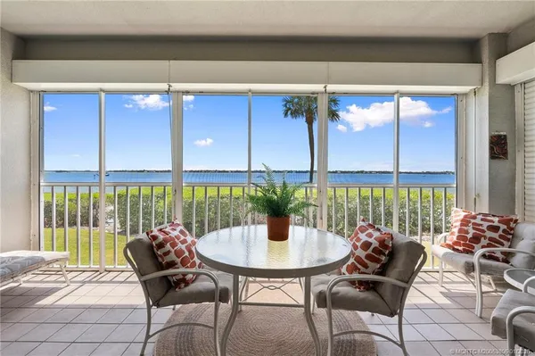 a table and chairs in front of a window