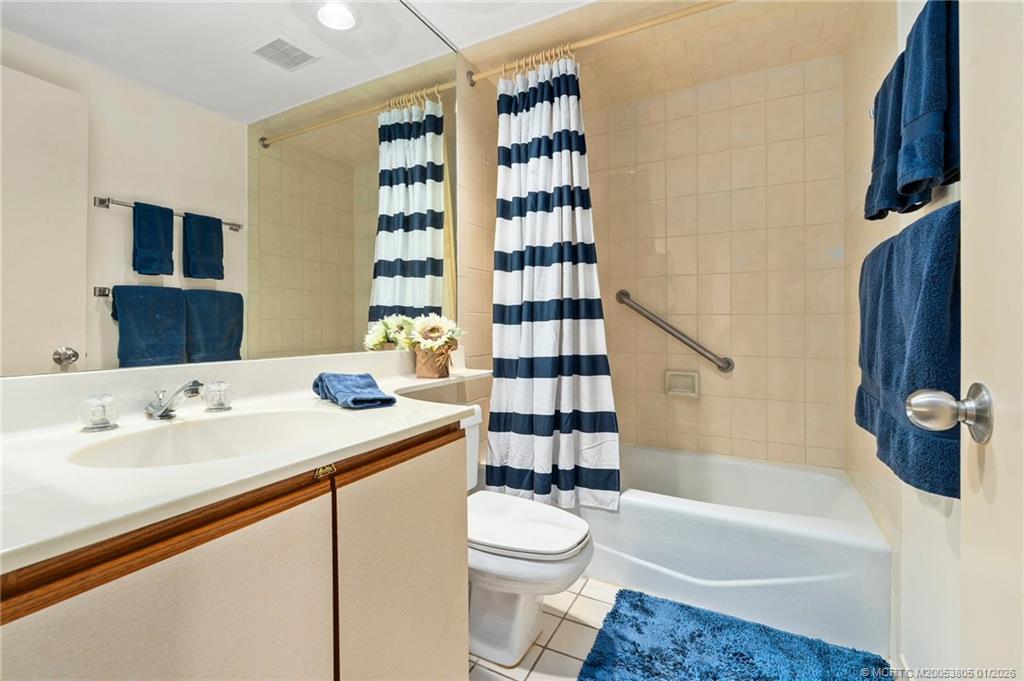 164 Northeast Edgewater Drive, Unit 2105 Jensen Beach, FL 34957 - Photo 21 of 35 a bathroom with a sink a toilet and shower