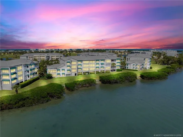 a view of a lake with houses in the background