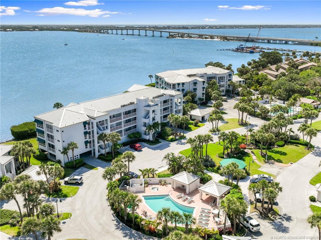 164 Northeast Edgewater Drive, Unit 2105 Jensen Beach, FL 34957 - Photo 35 of 35 a view of a lake with a building in front of it