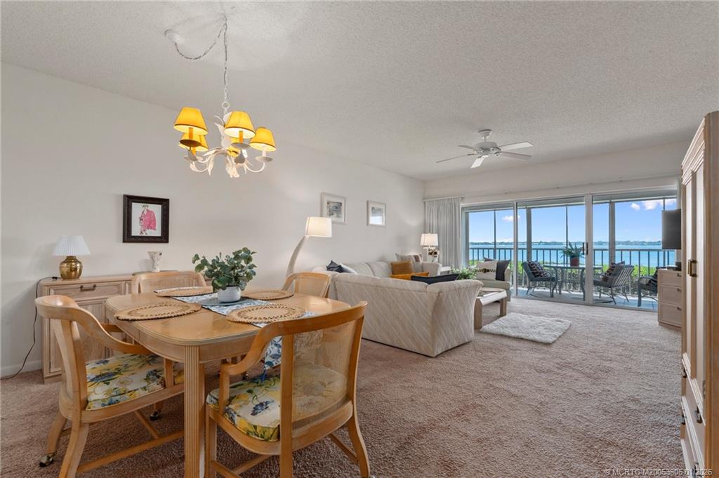 164 Northeast Edgewater Drive, Unit 2105 Jensen Beach, FL 34957 - Photo 6 of 35 a view of a dining room with furniture and chandelier