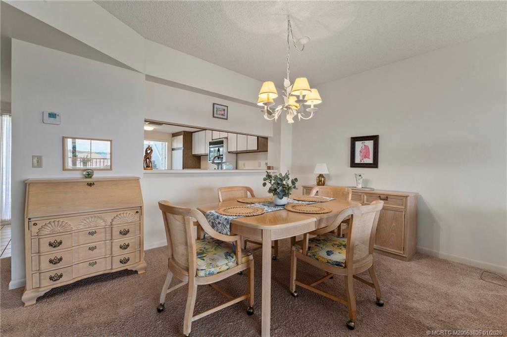 164 Northeast Edgewater Drive, Unit 2105 Jensen Beach, FL 34957 - Photo 7 of 35 a view of a dining room with furniture