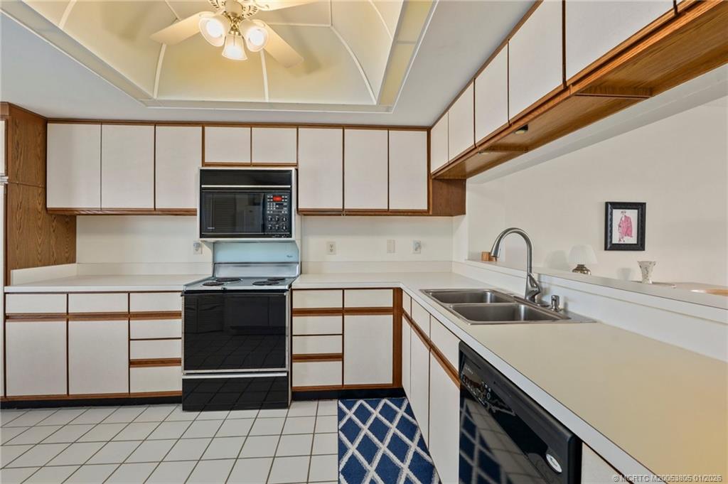 164 Northeast Edgewater Drive, Unit 2105 Jensen Beach, FL 34957 - Photo 8 of 35 a kitchen with stainless steel appliances a sink stove and cabinets