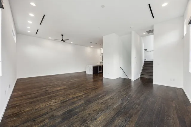 an empty room with wooden floor and fireplace