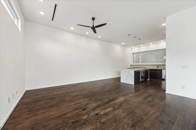 a kitchen with kitchen island white cabinets and stainless steel appliances