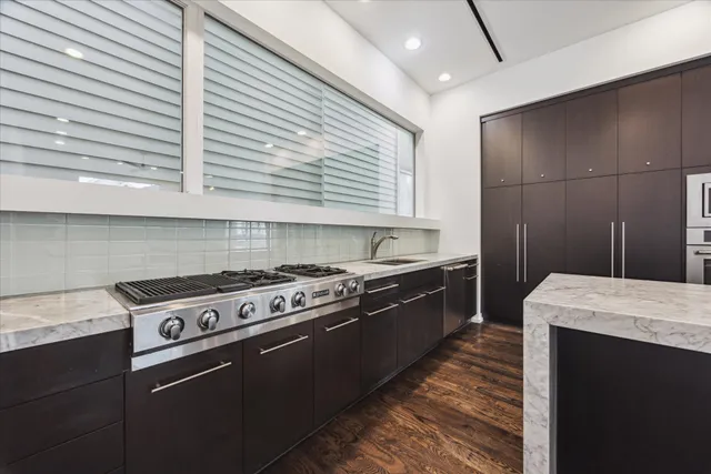 a kitchen with stainless steel appliances granite countertop a stove and a refrigerator