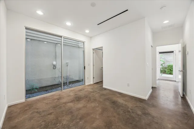 a kitchen with granite countertop a stove and a refrigerator with wooden floor