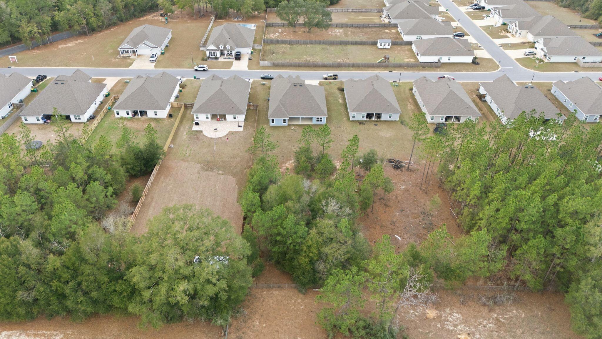 2452 Dakota Way Crestview, FL 32536 - Photo 6 of 29 an aerial view of a house with a yard and lake view
