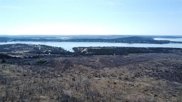 a view of an ocean beach and mountain