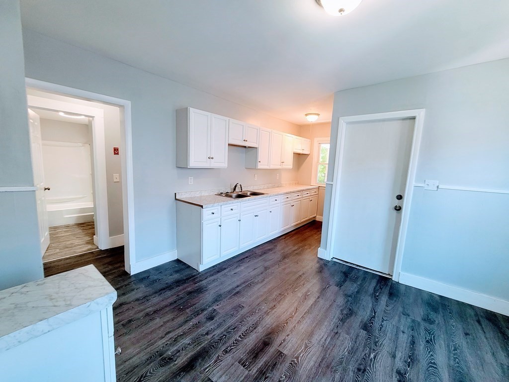 33-35 Algonquin Place Springfield, MA 01104 - Photo 5 of 10 a kitchen with a sink and wooden floor