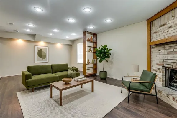 a living room with furniture and a potted plant