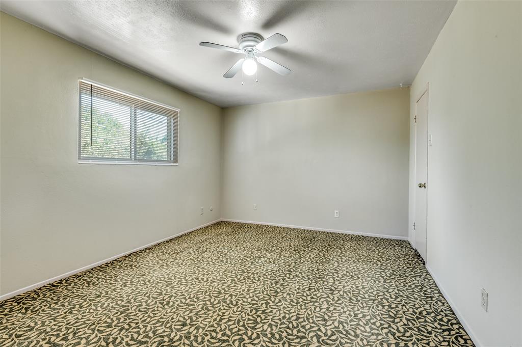 110 Crandall Road Irving, TX 75060 - Photo 11 of 13 an empty room with a ceiling fan and a window