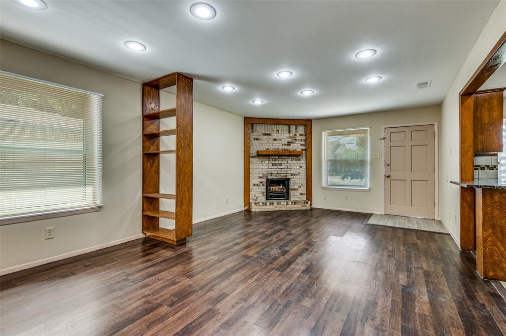 110 Crandall Road Irving, TX 75060 - Photo 2 of 13 a view of an empty room with a window and wooden floor