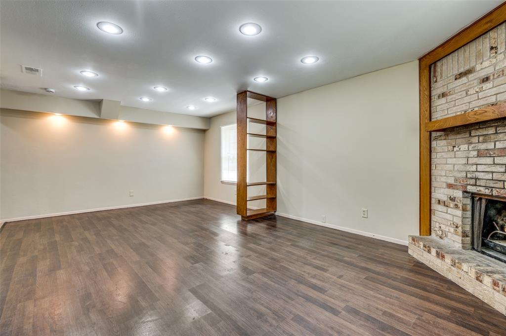 110 Crandall Road Irving, TX 75060 - Photo 3 of 13 a view of an empty room with wooden floor and a fireplace