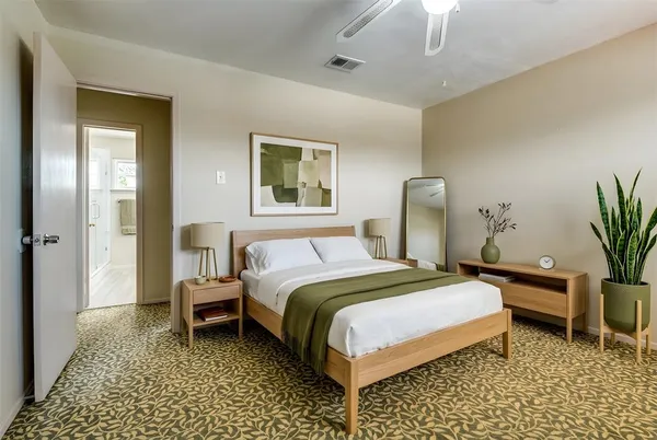 a bedroom with a bed and a table in it