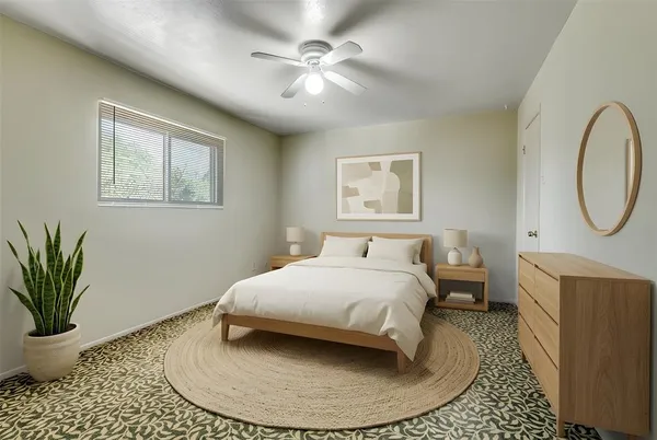 a bedroom with a bed and a potted plant