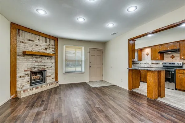 a view of kitchen with granite countertop cabinets and wooden floor