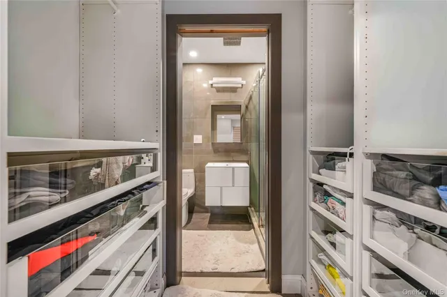 a bathroom with a toilet a sink and shower