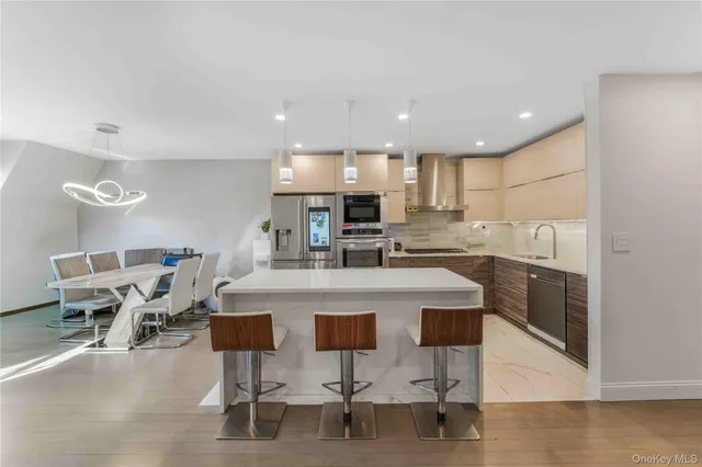 a kitchen with kitchen island cabinets and chairs in it