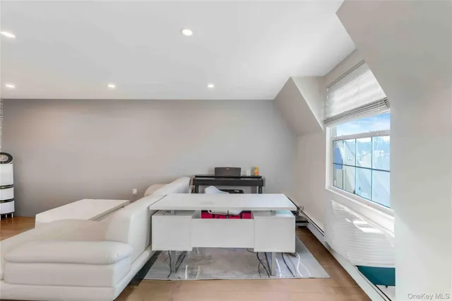 a room with a couch and a view of kitchen