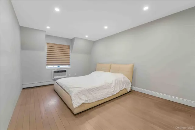 a bed sitting in a spacious bedroom next to a window