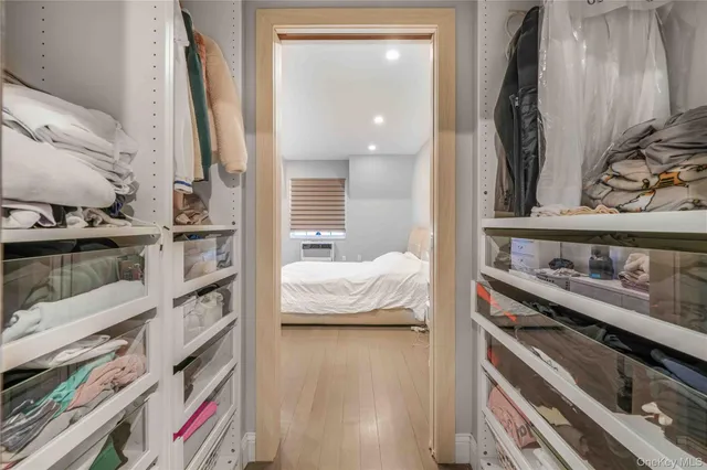 a view of walk in closet with clothes and shoes