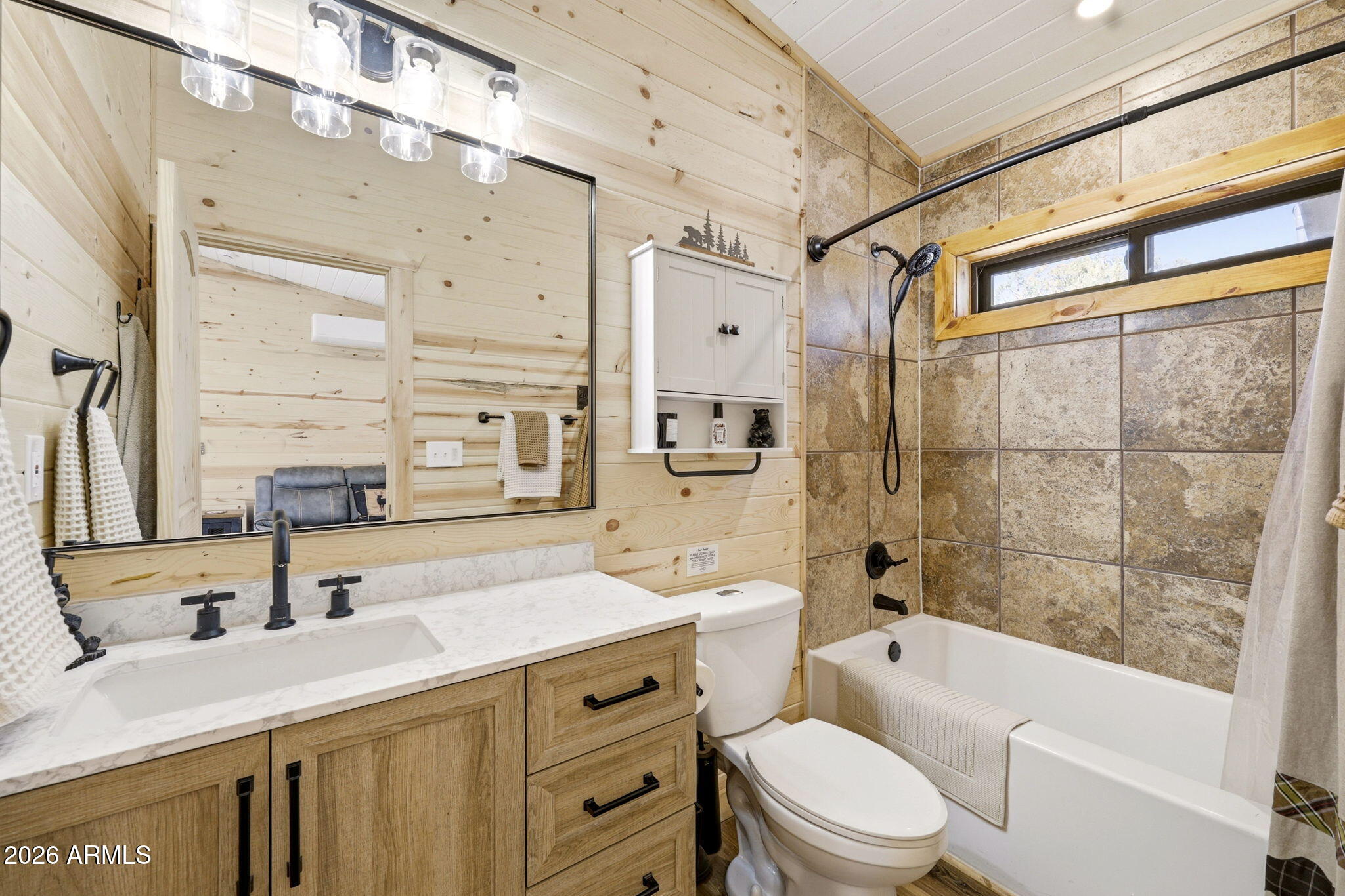 2787 Deer Hill Overgaard, AZ 85933 - Photo 12 of 44 a bathroom with a sink a toilet a mirror a bathtub and shower