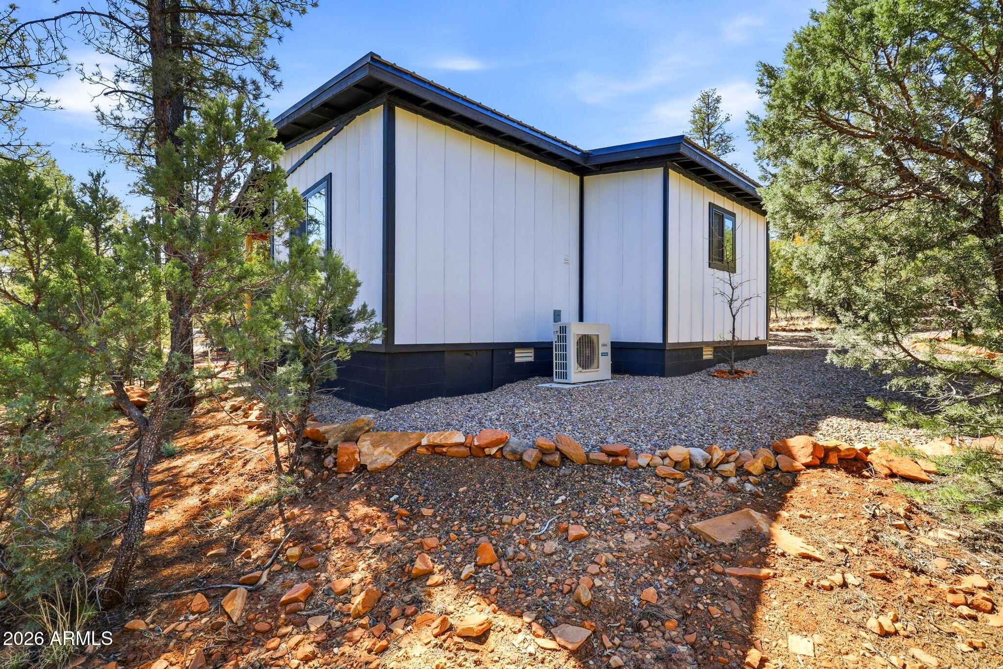 2787 Deer Hill Overgaard, AZ 85933 - Photo 16 of 44 a front view of a house with a yard