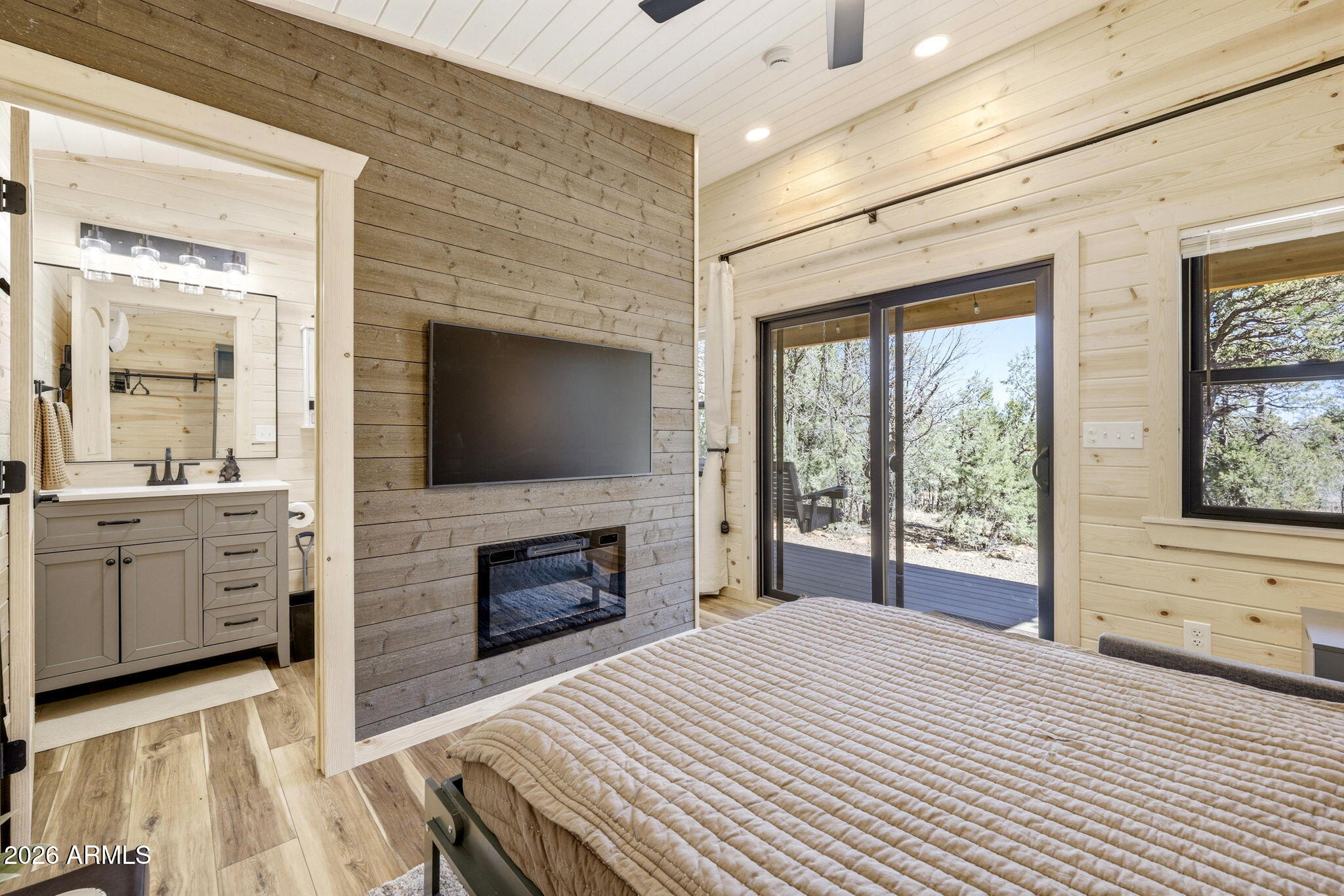 2787 Deer Hill Overgaard, AZ 85933 - Photo 24 of 44 a bedroom with a bed and a flat screen tv