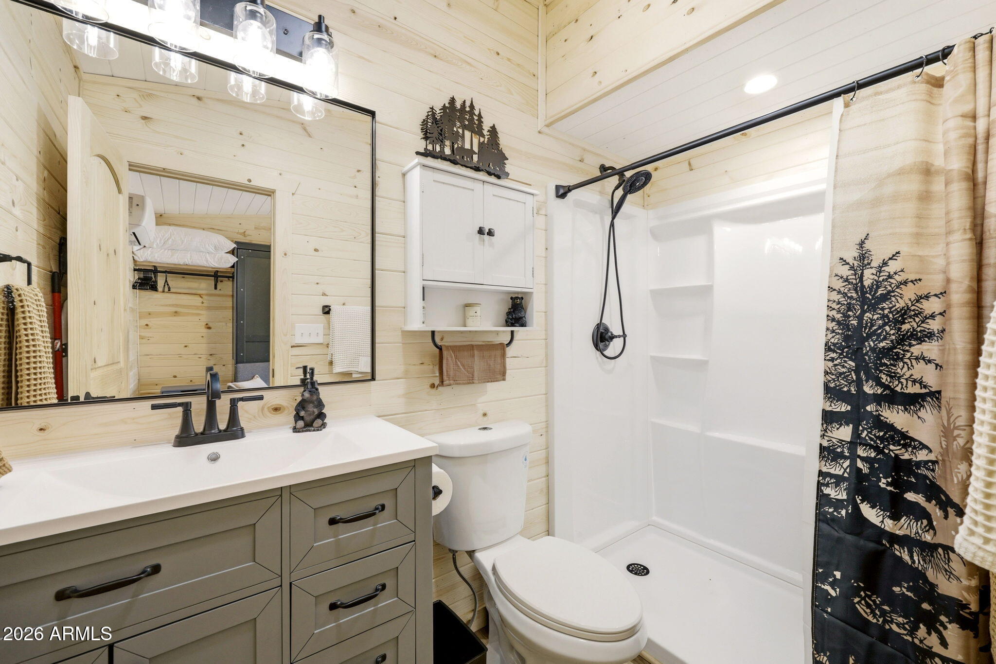 2787 Deer Hill Overgaard, AZ 85933 - Photo 27 of 44 a bathroom with a double vanity sink toilet mirror and shower