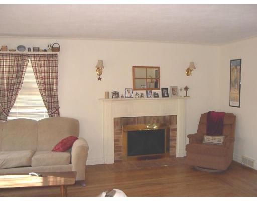 1418 Worcester Street Springfield, MA 01151 - Photo 5 of 8 a living room with furniture a window and a fireplace