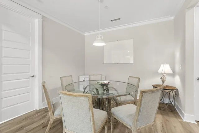 a view of a dining room with furniture and wooden floor