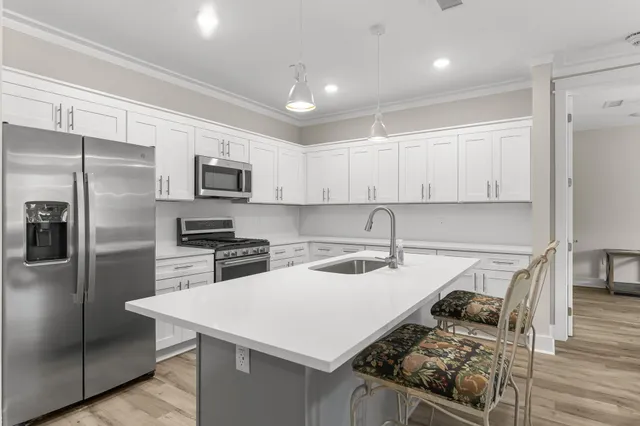 a kitchen with a stove a refrigerator and a sink