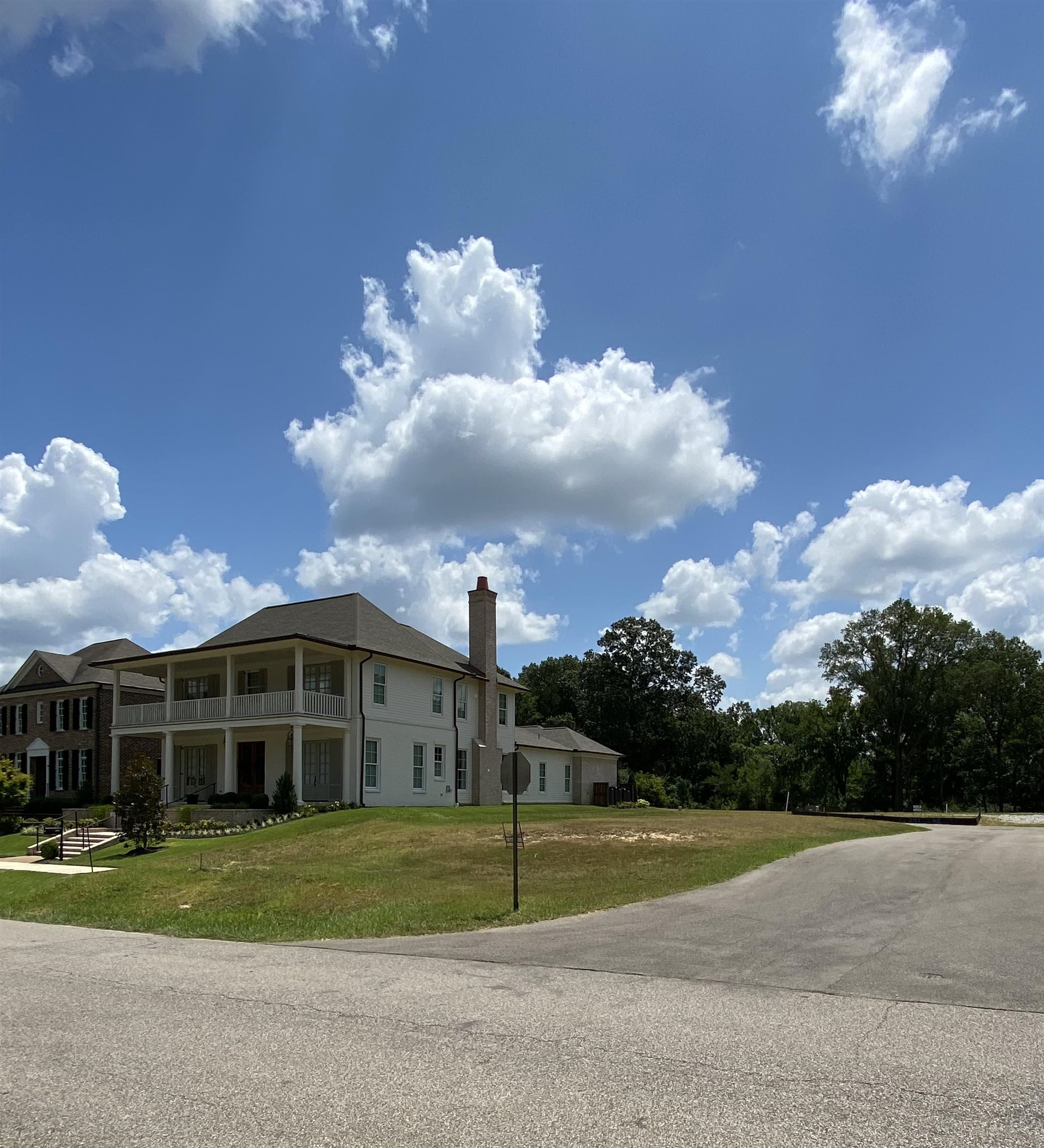 293 Washington Street Collierville, TN 38017 - Photo 3 of 5 View of property exterior with a balcony and a lawn