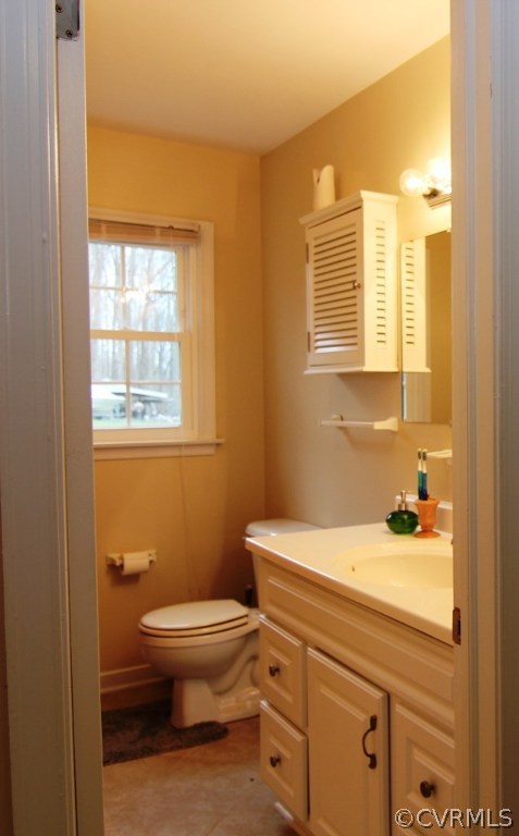 12801 Harrowgate Road Chester, VA 23831 - Photo 11 of 21 a bathroom with a sink a toilet and a window