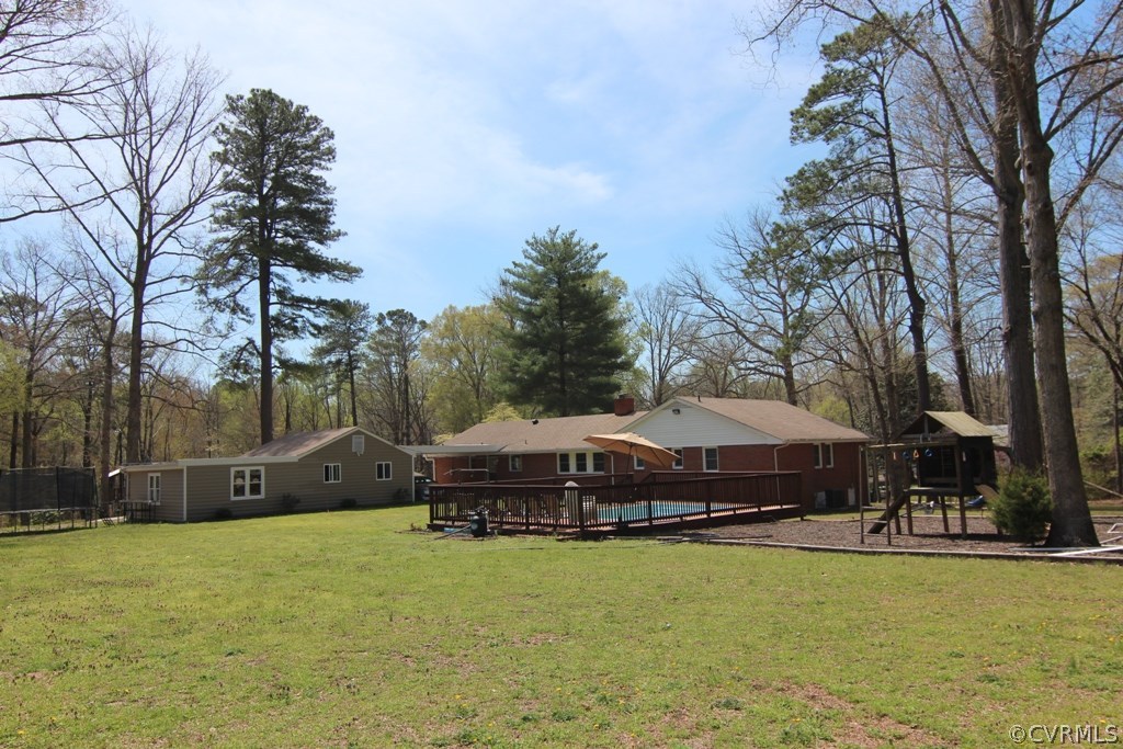 12801 Harrowgate Road Chester, VA 23831 - Photo 3 of 21 a swimming pool with outdoor seating and yard