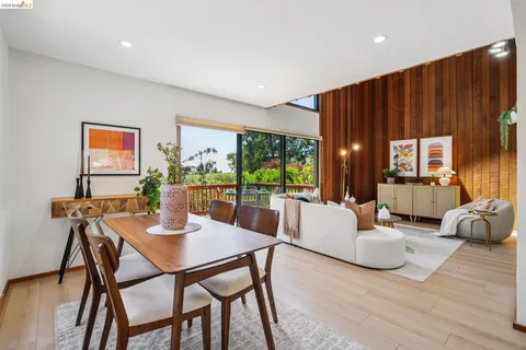 a dining room with furniture a chandelier and wooden floor