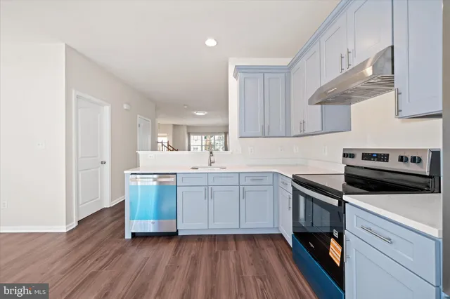 a kitchen with sink cabinets and stainless steel appliances