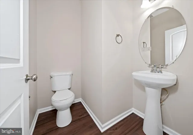 a bathroom with a sink toilet and a mirror