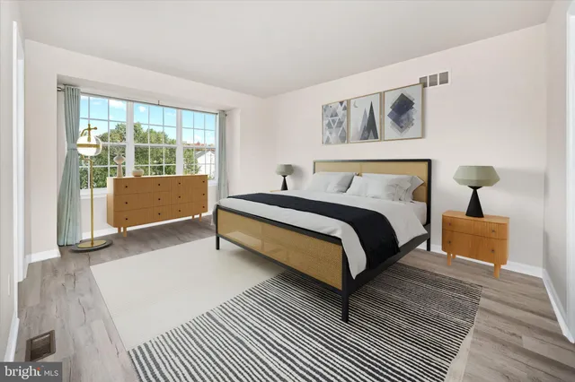 a bed room with a bed and a night stand