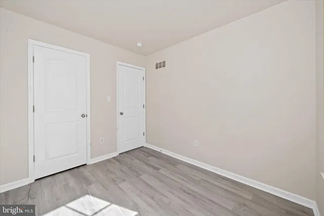 a view of room with wooden floor
