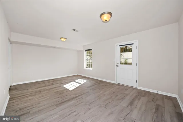 an empty room with windows and closet