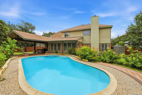 a view of a house with swimming pool and sitting area