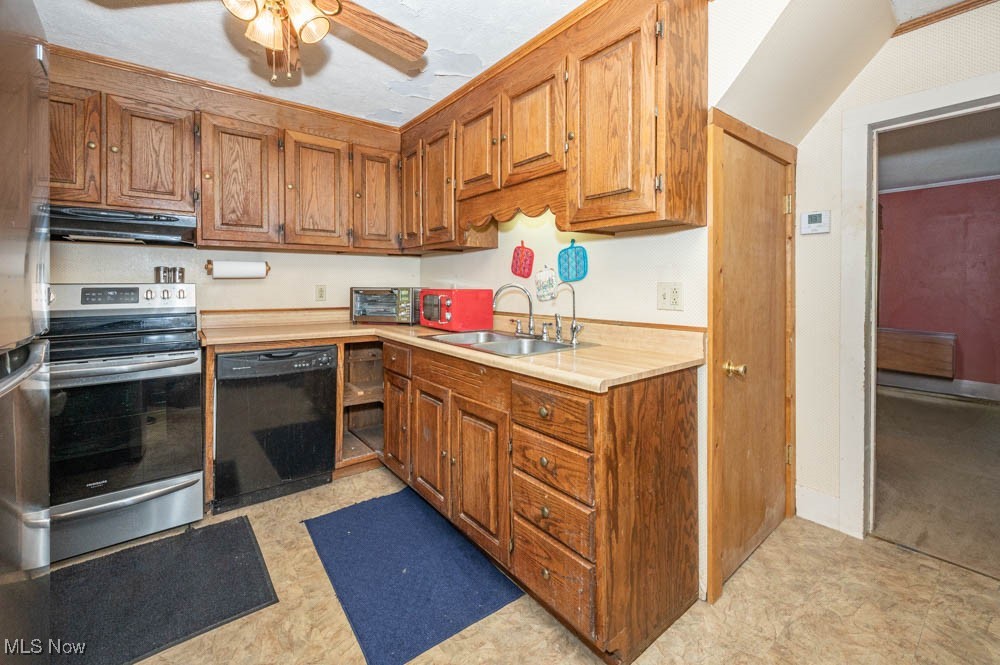 103 Valley Road Damascus, OH 44619 - Photo 3 of 27 Kitchen with sink, range with electric cooktop, light tile patterned floors, black dishwasher, and ceiling fan