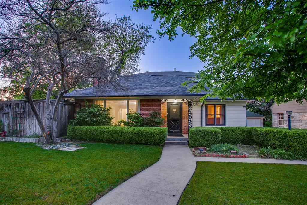 1439 Jr Drive Dallas, TX 75208 - Photo 1 of 39 a front view of a house with a garden and plants