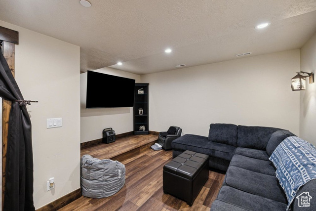 6117 North Rocky Ridge Road Peoa, UT 84061 - Photo 65 of 83 Living room featuring a textured ceiling and dark hardwood / wood-style flooring