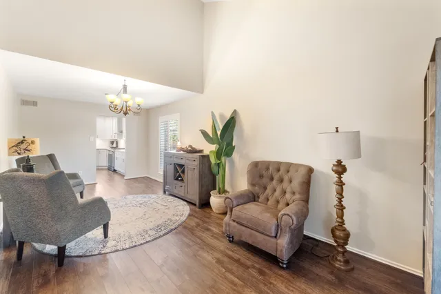 a living room with furniture and a chandelier