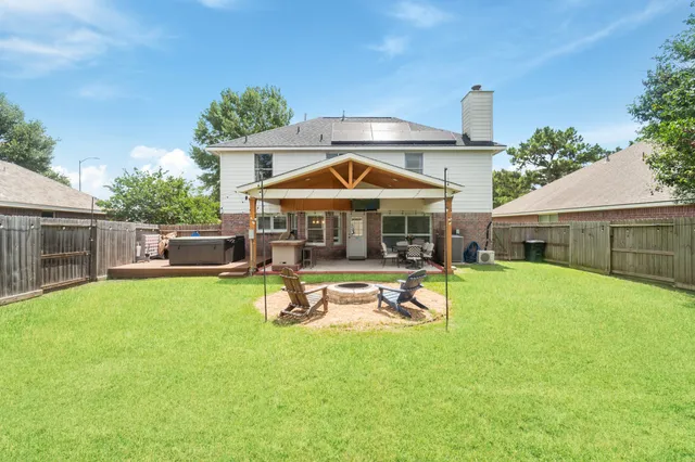 a view of a house with a yard patio and a slide