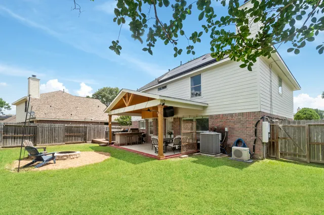 a view of a house with backyard porch and sitting area
