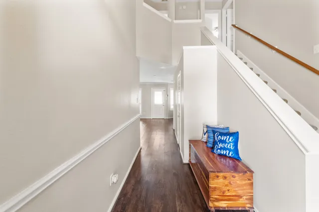 a view of hallway with wooden floor